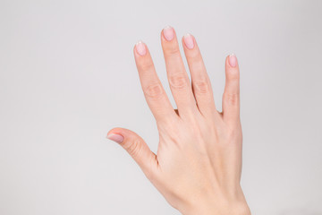 Closeup view photography of white female hand with raised five fingers up.