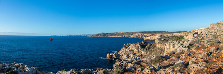 Beautiful view of blue mediterranean sea and rocky shore with cliffs at sunny winter day in Malta