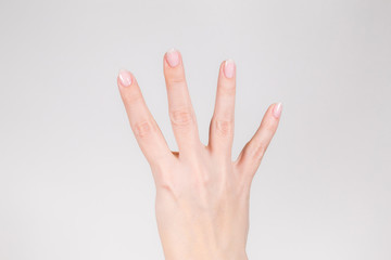 Closeup view photography of white female hand with raised four fingers up.