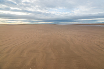 Fototapeta na wymiar Ripples in the sand, on the vast Beach in Formby, Merseyside