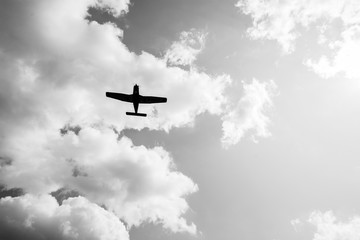 airplane flying over the sky with white clouds