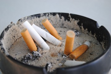 Assorted cigarette butts  in an ashtray