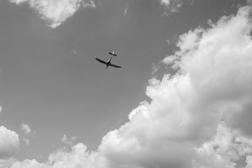 airplane flying  with white clouds