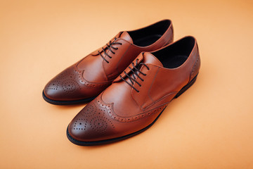 Oxford male brogues shoes. Men's fashion. Classical brown leather footwear.