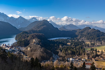 Aerial Panorama view of the Bavarian Alps mountains with the famous Hohenschwangau Castle and Alpsee lake, Schwansee lake on a sunny day in winter, Schwangau, Bavaria, Germany