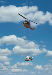 Fototapeta na wymiar Helicopter lifting a car