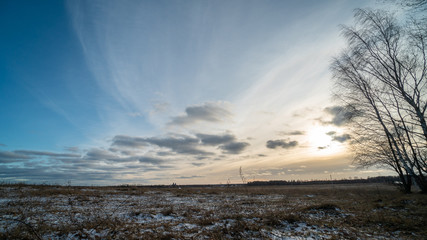 Beautiful setting sun over frozen field
