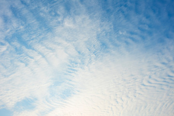 Blue sky with white clouds, (Cirrocumulus clouds)  in blue sky on sunny peaceful day.