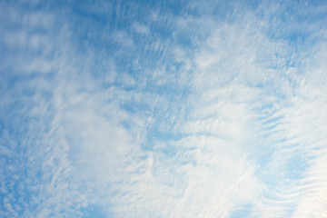 Blue sky with white clouds, (Cirrocumulus clouds)  in blue sky on sunny peaceful day.