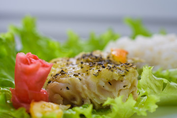 Still life with baked fish, ginger, lemon, rice