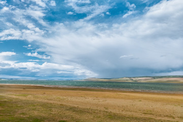 Obraz premium beautiful blue sky with clouds over a lake with a sandy beach, summer landscape in Russia