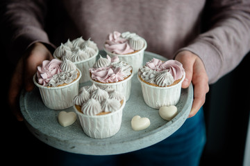 Tasty cupcakes. Homemade vanilla muffin cupcake with cream buttercream icing. Valentine sweets. ...