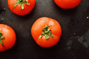 Fresh tomatoes on a dark background. Top view. Red Tomatoes.