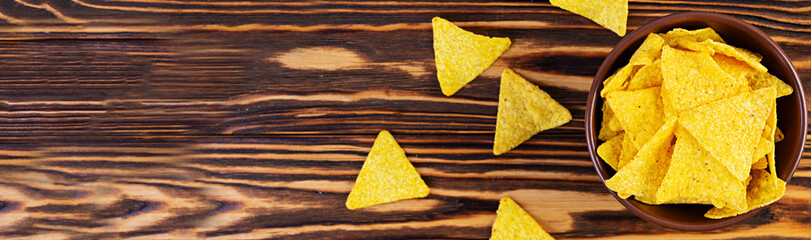 Mexican nachos with cheese. Corn chips isolated on wooden background