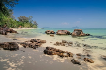 view seaside of many arch rocks on white sand beach with blue-green sea and blue sky background, Ko Bulon Le island, Satun province, southern of Thailand.