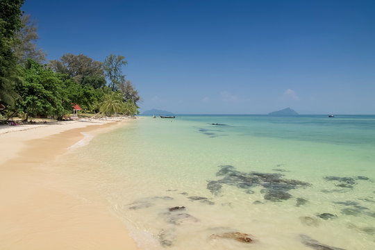 view seaside of white sand beach and blue-green sea with blue sky background, Ko Bulon Le island, Satun province, southern of Thailand.