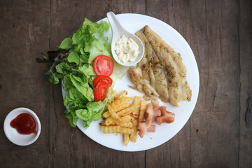 fish steak , catfish steak with French fries and salad