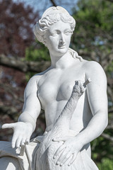Old statue of a sensual naked Renaissance Era woman in the park of Potsdam, Germany, details, closeup