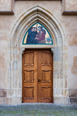 Fototapeta na wymiar Ancient wooden door in stone wall.