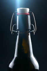 beer bottle with lid dark glass on a dark background