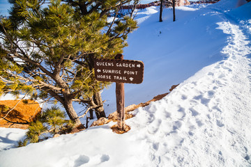 Sunrise point, Queen's garden & Horse trail sign post in Bryce Canyon National Park in Winter covered with snow