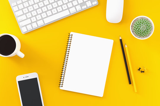 Workplace top view on a desk table over a yellow background with copyspace.