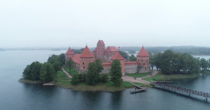 Trakai, Lithuania: medieval gothic Island castle, located in Galve lake and town in the background. Aerial above summer UAV top view, flat lay of the most beautiful Lithuanian landmark.