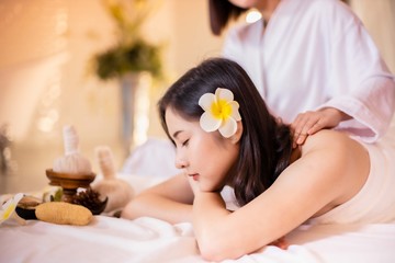 Asian Beautiful, young and healthy woman in spa salon. Massage treatment spa room  . Traditional medicine and healing concept.