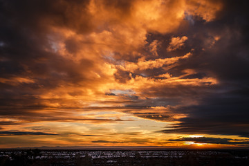 Dramatic orange sunset on the Grand Canyon after a storm 