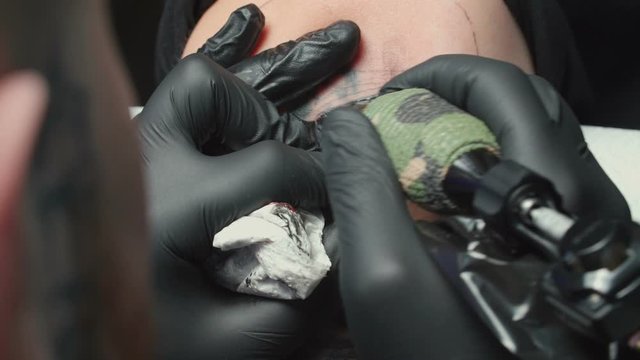 Video of tattooist getting tattoo of snake for woman