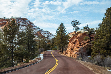 Red road and snowy mountains of Zion National Park  in winter