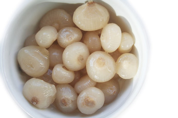 Pickled little pearl onions in a bowl isolated on white background
