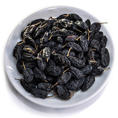 Dark raisins on a white isolated background. Food brown-blue grapes delicious for your design for the site. kitchen theme