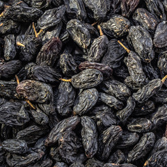 Dark raisins on a white isolated background. Food brown-blue grapes delicious for your design for the site. kitchen theme