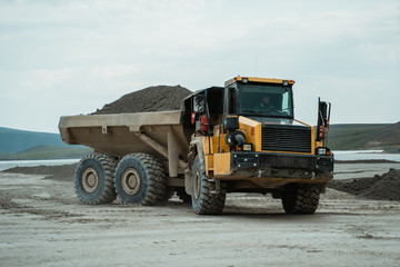 Career dump truck in the background of the mine.