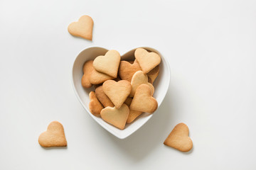 Valentines day greeting card with heart shaped cookies on white. View from above.