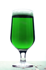Saint Patrick's Day green beer closeup against white background. Traditional Saint Patrick's Day drink in a glass isolated on white