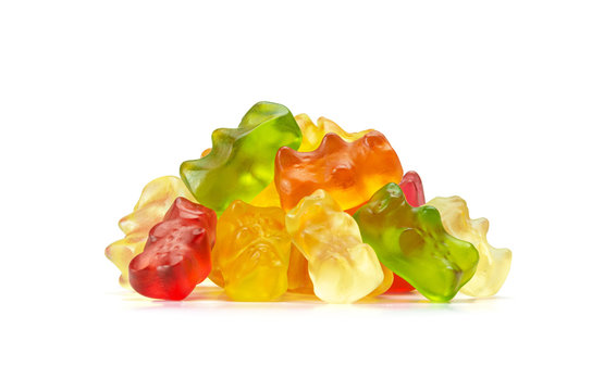 Macro of Assorted Fruit Flavored Gummy Bears or Cannabis Edibles Isolated on White Background