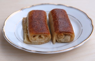 Pancakes with filling on plate ready for food side view