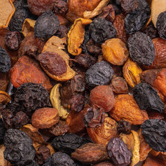 Mix of dried fruits on a white isolated background. Food grapes, apple, raisins, hazelnuts, dried apricots for your website design. kitchen theme