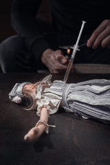 Children's toy on a wooden table, a syringe with a drug is stuck in the toy. Concept of the problem...