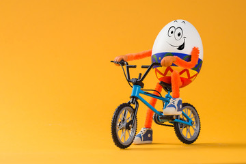 Easter egg with pointed ornament sitting on a bicycle