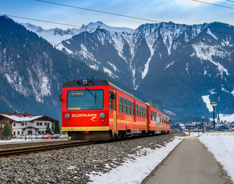 MAYRHOFEN, TYROL, AUSTRIA - JANUARY 25, 2020 : Red train on the Zillertal railway In the background of Alpine mountains.