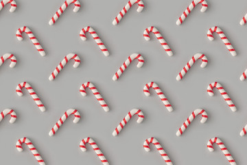 Fototapeta na wymiar Christmas pattern with candies on pastel gray background. Minimal holiday wrap concept.