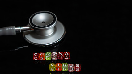 Colorful text "Corona virus" and   Medical stethoscope  put on  Black background. corona virus Concept.