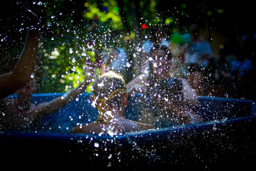 Waterdrops splashing with people in the background in a hottub 