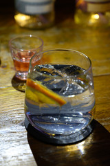 Glass of gin with tonic water, orange and ice