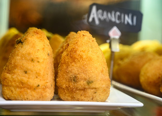 Tasty italian street food, deep fried aranchini rice balls with different filling