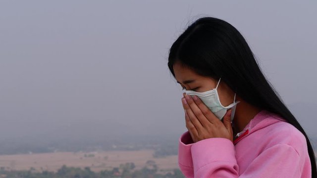 Asian women wearing dust mask and headache protect from wuhan coronavirus china health emergency.