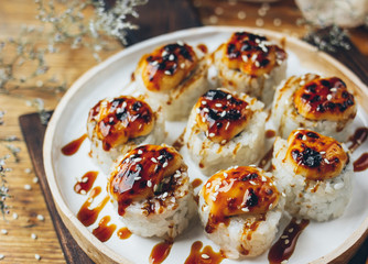 Sushi with a cheese cap